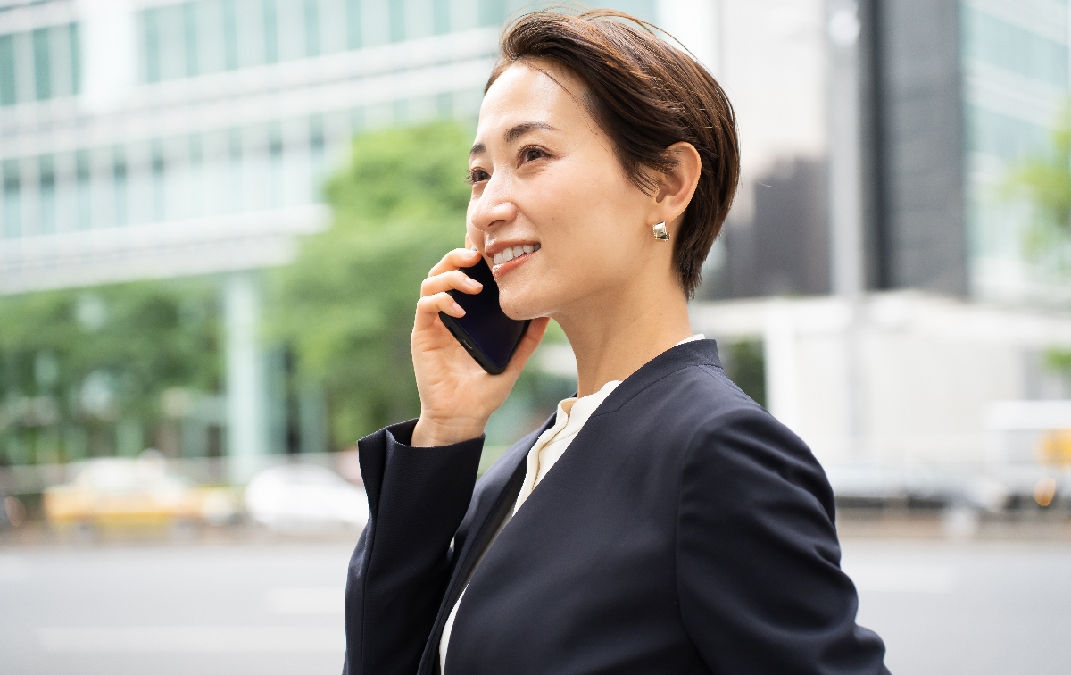 A pretty Japanese woman wearing a suit and doing business and going around